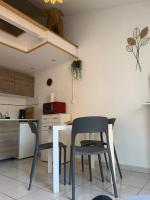 a kitchen with two chairs and a table in a room at Duplex Raphael- Wi-fi et parking privé in Toulon