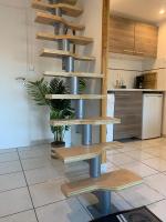 a kitchen with wooden shelves in a room at Duplex Raphael- Wi-fi et parking privé in Toulon