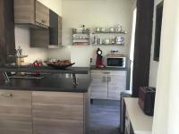 a kitchen with a counter with a bowl of fruit on it at le gîte de Martine en Baie de Somme in Lanchères