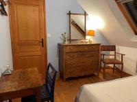 a bedroom with a dresser with a mirror and a table at Maison Locmaria, 6 pièces, 10 personnes - FR-1-418-5 in Locmaria