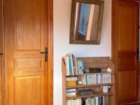 a room with a door and a book shelf with books at Maison Locmaria, 6 pièces, 10 personnes - FR-1-418-5 in Locmaria