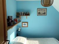 a blue wall with a bed in a room at Maison Locmaria, 6 pièces, 10 personnes - FR-1-418-5 in Locmaria