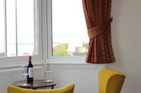 a table with a bottle of wine and two glasses at The Crown Hotel in Morecambe