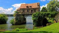a house sitting on a bridge over a river at Appt cosy coeur historique+park, 5mn gare Vernon in Vernon