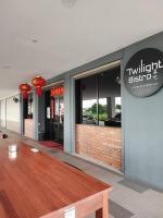 a restaurant with a wooden table in front of a building at Kuching Luxurious Town Area Apartment in Kuching