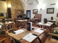 a dining room with wooden tables and chairs at Hotel Tugasa Convento San Francisco in Vejer de la Frontera