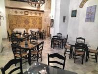 a restaurant with tables and chairs in a room at Hotel Tugasa Convento San Francisco in Vejer de la Frontera