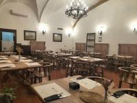 a large room with wooden tables and chairs at Hotel Tugasa Convento San Francisco in Vejer de la Frontera