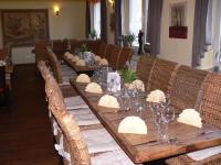 a long wooden table with chairs and wine glasses at Raffelberger Hof in Mülheim an der Ruhr