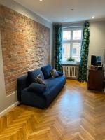Televízia a/alebo spoločenská miestnosť v ubytovaní Apartament Koci Łeb