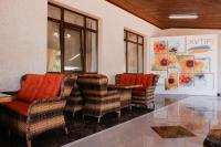 a room with chairs and a table with orange pillows at Готель Хутір in Malyye Khutora