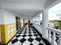 a porch with a checkered floor at Acajou in Sainte-Luce