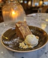 a piece of cake and ice cream on a plate at The Coal Exchange Hotel in Cardiff