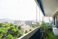 an apartment balcony with a view of a city at Grand appartement avec balcon et parking in Marseille