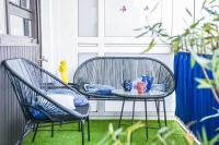 a patio table with two chairs and vases on it at Grand appartement avec balcon et parking in Marseille