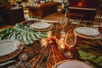 a table with wine glasses and plates on it at Cerro Tusa Glamping in Titiribí