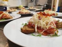 a plate of food on a table with plates of food at Alpen Chalet - Charme Mountain Hotel - in Schilpario