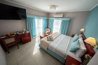 a bedroom with a bed and a desk with a chair at Hotel Riviera in Mar del Plata