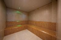a room with a sauna with brown tiles and green lights at Hotel Riviera in Mar del Plata