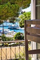 a balcony with a view of a marina at Hotel Les Palmiers in Sainte-Maxime