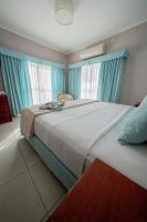 a bedroom with a large bed with blue curtains at Hotel Riviera in Mar del Plata