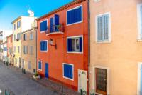 a row of colorful buildings on a street at Hotel Les Palmiers in Sainte-Maxime