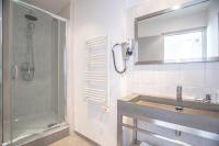 a bathroom with a shower and a sink at Hotel Les Palmiers in Sainte-Maxime