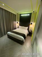 a bedroom with a large bed in a room at Boda Hotel in Taichung
