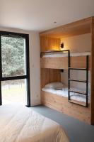 a bedroom with two bunk beds and a window at L&#39;Orée des Sources in Volvic