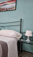 A bed or beds in a room at Terrazza del Santo 2,0 - La Terrazza nel cuore di Napoli