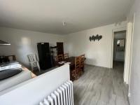 a living room with a bed and a dining room at Logement neuf en face de la forêt. Accès cour. in Bagnoles de l&#39;Orne