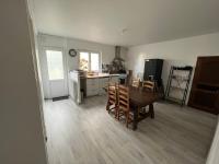 a kitchen and dining room with a table and chairs at Logement neuf en face de la forêt. Accès cour. in Bagnoles de l&#39;Orne