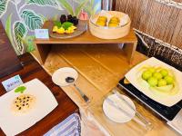 a table with two plates of fruit on it at Kenting Summerland Garden Resort in Eluan