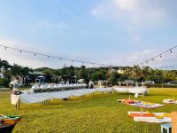 a long line of tables and chairs in a field at Kenting Summerland Garden Resort in Eluan