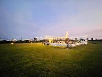 a group of tables in a field at night at Kenting Summerland Garden Resort in Eluan