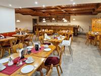 a dining room with wooden tables and chairs at Ferien vom Ich, Bayerischer Wald, Hotel & Restaurant in Neukirchen