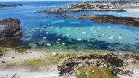 an aerial view of a beach with boats in the water at AR PENNITI - Magnifique maison en pierre proche plage in Landéda