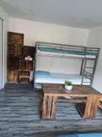 a room with a table and a bunk bed at Studio indépendant climatisé in Veigné
