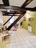 a living room with green walls and white tile floors at Chambres d&#39;hôtes Chez Caroline in Colmar