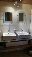 a bathroom with two sinks and two mirrors at Domaine Lagardelle Rocamadour in Rocamadour
