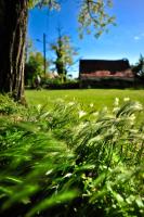 a field of green grass with a building in the background at Domaine Lagardelle Rocamadour in Rocamadour