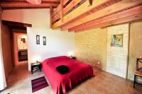 a bedroom with a red bed in a room at Domaine Lagardelle Rocamadour in Rocamadour