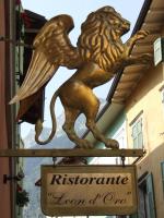 Appartamenti LEON D'ORO في ريفا ديل غاردا: لافتة لمطعم عليها صورة أسد على مبنى