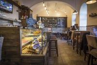 een restaurant met een bakkerij met een bar en tafels bij Volenter Lux Apartment Zero in Baja