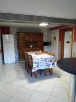 a kitchen with a table with a table cloth on it at gite chez Maise in Le Val-dʼAjol