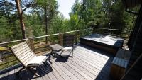 a wooden deck with a bench and a hot tub at Villa Mustikka in Ekenäs