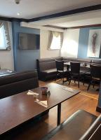 a living room with a couch and a table and chairs at Waverley Hotel in Peterhead