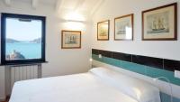 A bed or beds in a room at Miralunga Villetta Gialla