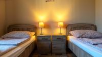 two beds in a room with two lamps on them at Király Panzió in Tolcsva