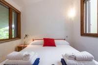 A bed or beds in a room at Domus Carlotta Apartment with sea view Villasimius
